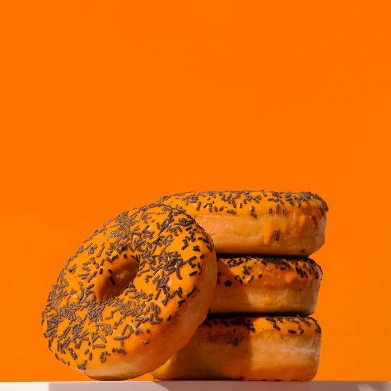Mini crispy donut with Thai tea glaze and orange drip